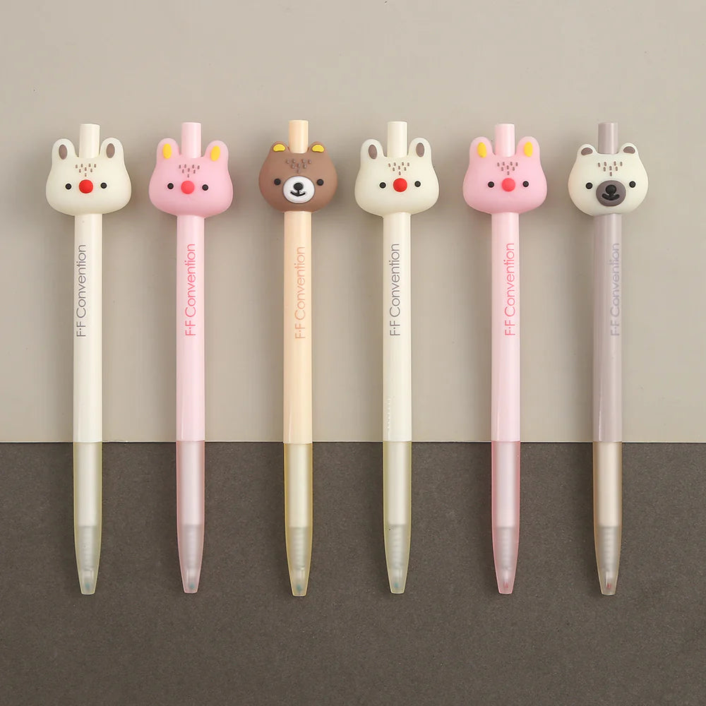 A row of 6 woodland animal gel pens featuring a cream color bunny, pink bunny, brown bear, cream bunny, pink bunny, and cream bear on a light tan background