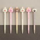 A row of 6 woodland animal gel pens featuring a cream color bunny, pink bunny, brown bear, cream bunny, pink bunny, and cream bear on a light tan background