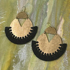 Pair of handmade brass dangle earrings with black color thread fringe detail on a metallic painting background