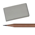 A kneaded eraser artist sketching tool next to a graphite pencil on a white background.