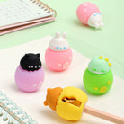 Cute colorful pencil sharpeners designed like baby animals hatching out of eggs on a mint green background with notebooks and a pencil being sharpened