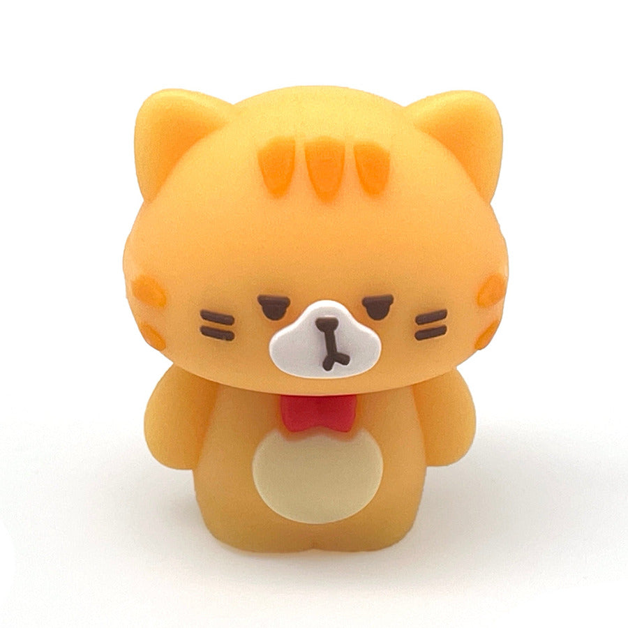 A small orange kawaii style cat pencil sharpener with a white snout, black facial details, and a red bow tie, centered on a plain white background.