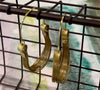 Video capture of hanging hoop earrings handmade from brass