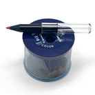 A very stubby black wood rainbow pencil with a clear plastic pencil extender sitting on top of a blue KUM color-combi pencil sharpener against a white background.