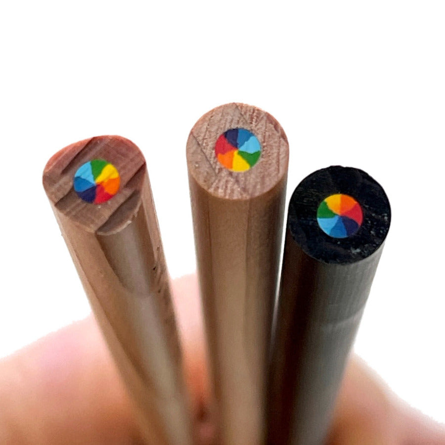 Three wooden rainbow pencils showing the multi-color core with  7 colors swirl in 1 pencil, held in a hand against a white background.