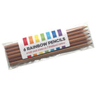 A pack of 6 wooden rainbow pencils in a clear cello bag with a white label, photographed on a plain white background.