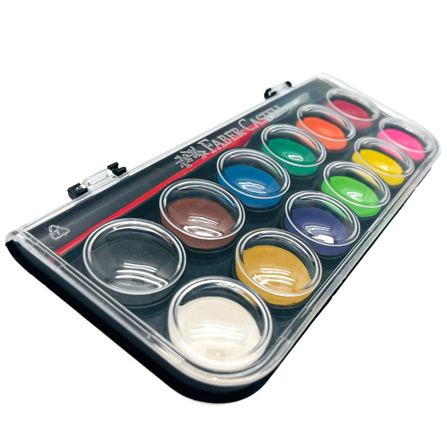 Set of 12 watercolor paints with a brush on a white background