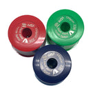 Three cylindrical wax crayon sharpeners in red, green, and blue on a white background