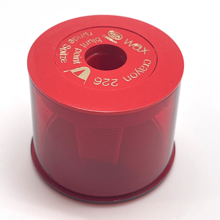 A red KUM jumbo crayon or jumbo pencil sharpener on a white background