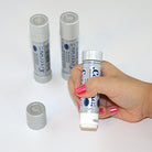 Child hand holding a glue stick with white background